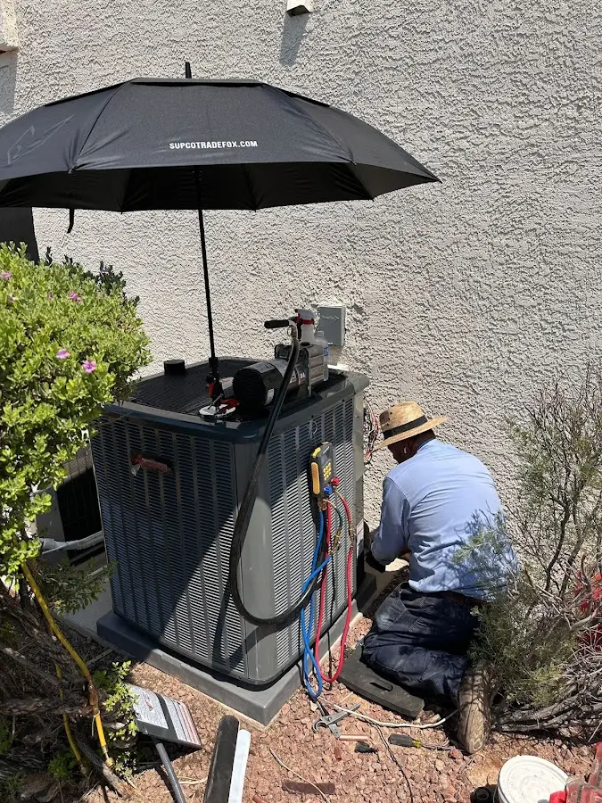 HVAC technician performing outdoor AC maintenance in San Leon